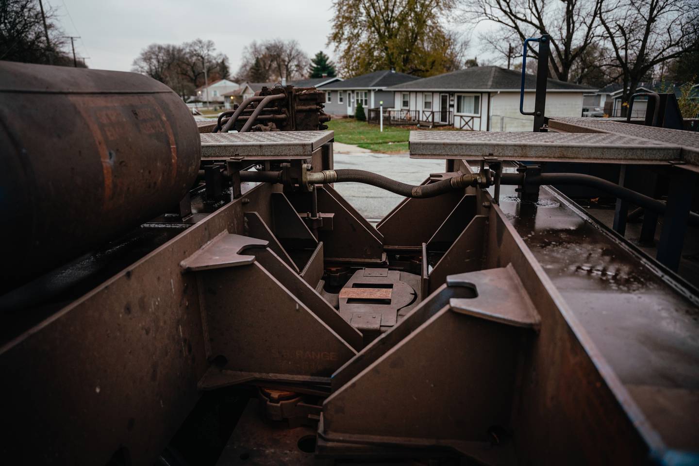 A photograph of the coupler joint on a train. The metal appears rusty and caked in sediment.